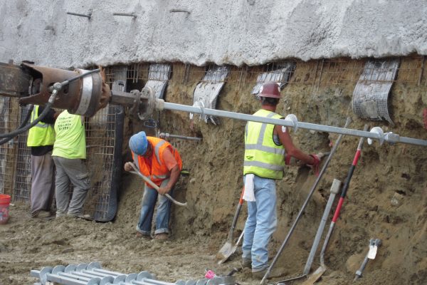 Earth retention using soil screws and soil nails